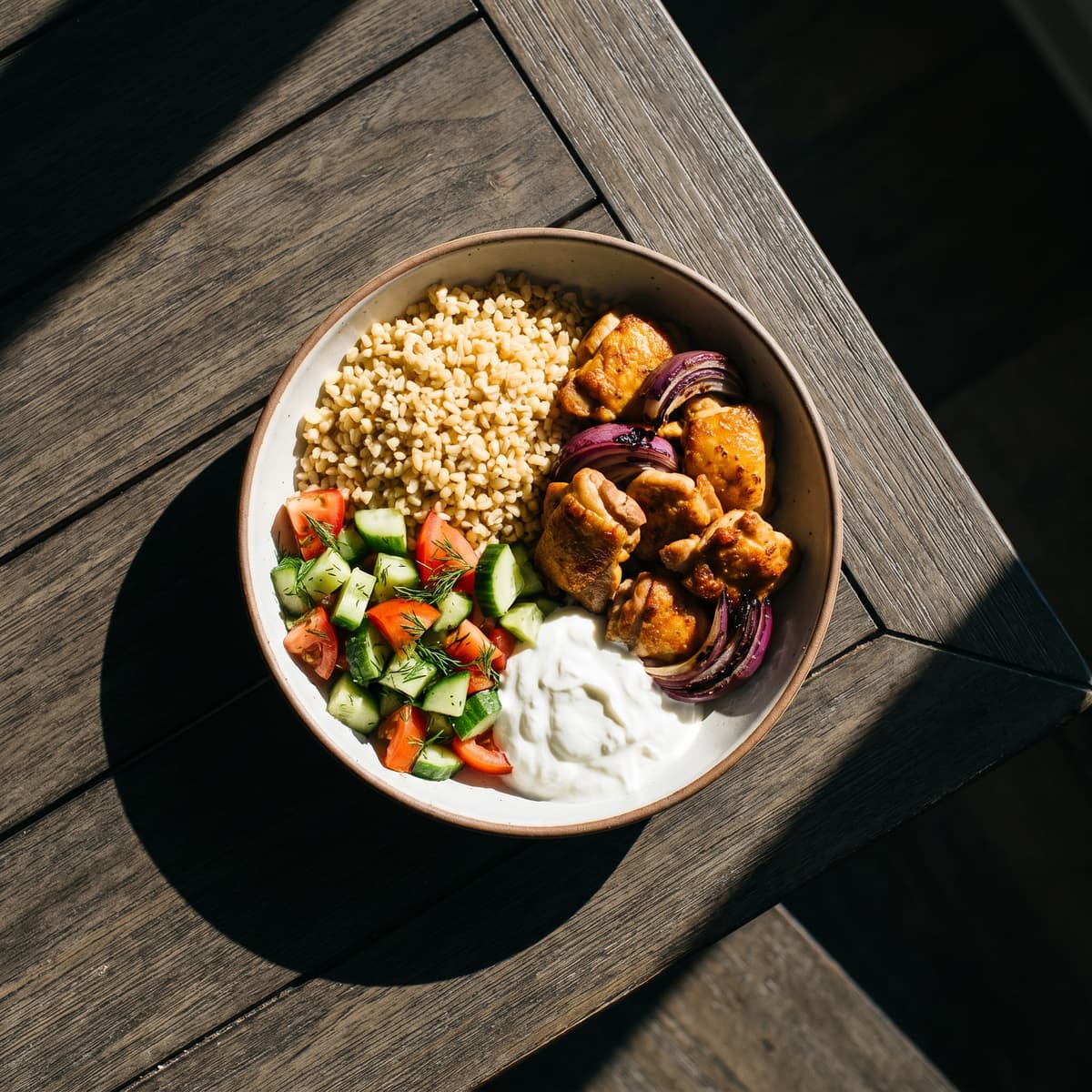 AI-generated photo: Air-fryer chicken bowl with bulgur, cucumber-tomato salad and yogurt